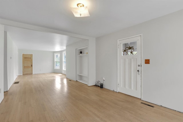 3504 W 2nd Ave, Spokane, WA 99224 - unfurnished living room featuring light wood-style flooring and built in shelves