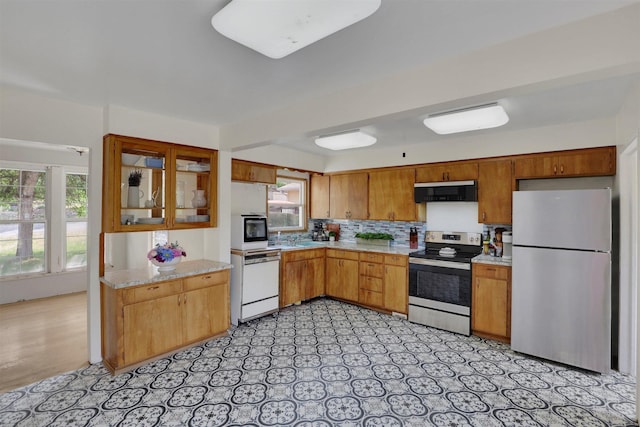 3504 W 2nd Ave, Spokane, WA 99224 - kitchen featuring stainless steel appliances, ventilation hood, plenty of natural light, and tasteful backsplash