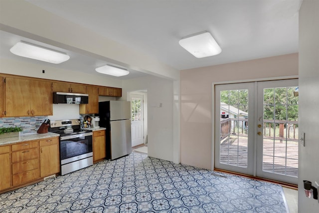 3504 W 2nd Ave, Spokane, WA 99224 - kitchen featuring stainless steel appliances, light countertops, brown cabinetry, and tasteful backsplash