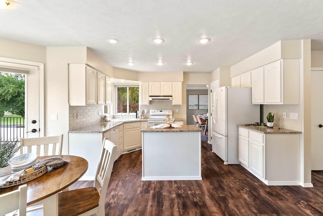 14 W Elcliff Ave, Spokane, WA 99218 - kitchen featuring white appliances, under cabinet range hood, a kitchen island, dark wood finished floors, and recessed lighting