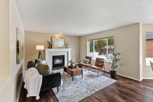 14 W Elcliff Ave, Spokane, WA 99218 - living area with a tile fireplace, dark wood-type flooring, and a textured ceiling