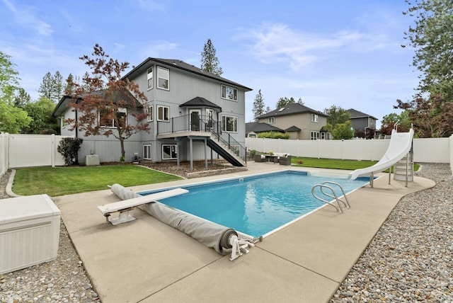 14 W Elcliff Ave, Spokane, WA 99218 - view of swimming pool featuring a diving board, stairs, and a fenced backyard