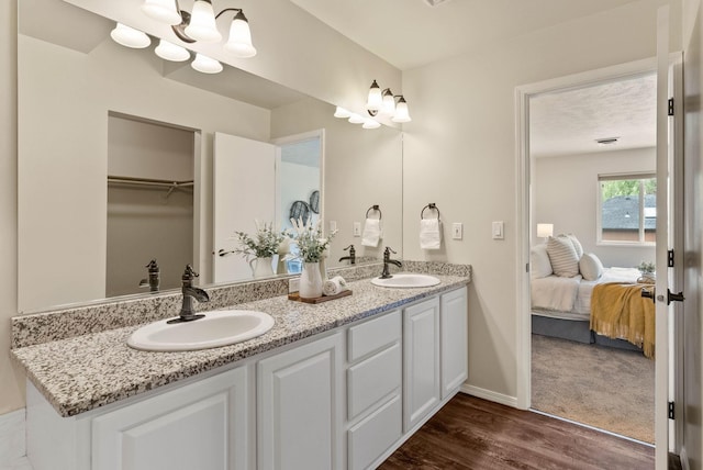 14 W Elcliff Ave, Spokane, WA 99218 - ensuite bathroom featuring double vanity and wood finished floors