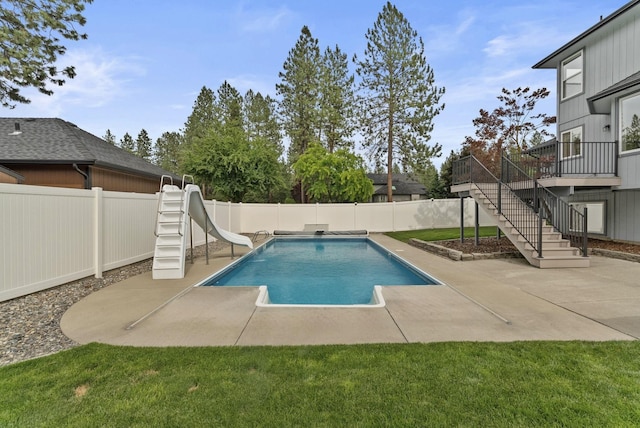 14 W Elcliff Ave, Spokane, WA 99218 - view of swimming pool featuring a water slide, a fenced backyard, a patio, stairs, and a deck