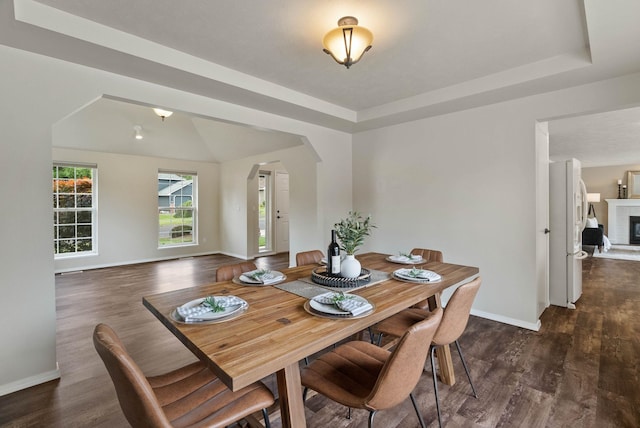 14 W Elcliff Ave, Spokane, WA 99218 - dining area with arched walkways, dark wood-style flooring, and a tiled fireplace