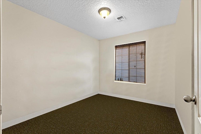 7619 S Camille Ct, Cheney, WA 99004 - spare room with dark carpet and a textured ceiling