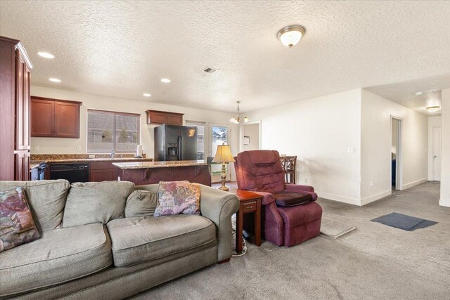 7619 S Camille Ct, Cheney, WA 99004 - carpeted living room with recessed lighting, a textured ceiling, and a chandelier