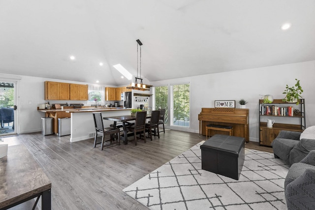 5706 W Excell Ave, Spokane, WA 99208 - living room featuring lofted ceiling, light wood-style flooring, healthy amount of natural light, and recessed lighting