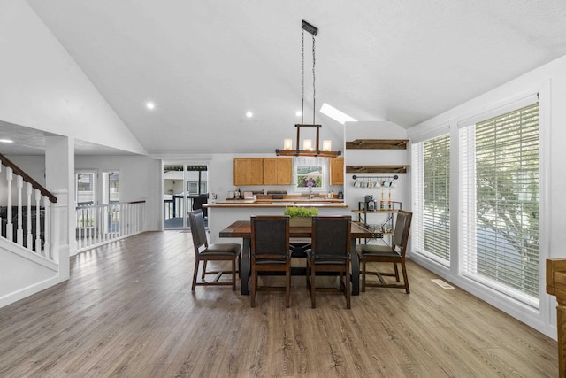 5706 W Excell Ave, Spokane, WA 99208 - dining space with light wood-style flooring, high vaulted ceiling, plenty of natural light, and stairs