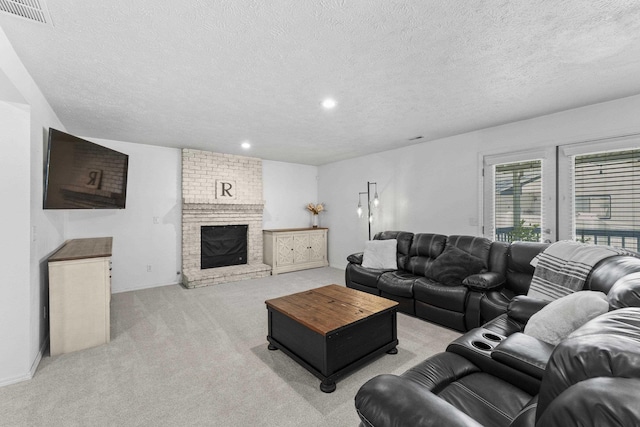 5706 W Excell Ave, Spokane, WA 99208 - living room featuring light colored carpet, a textured ceiling, recessed lighting, and a brick fireplace