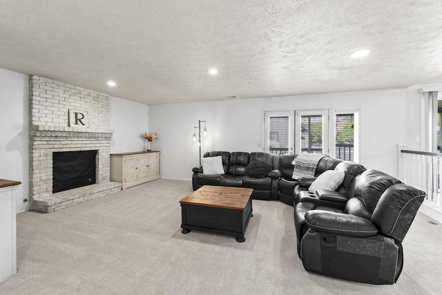 5706 W Excell Ave, Spokane, WA 99208 - carpeted living room featuring a textured ceiling, recessed lighting, and a brick fireplace