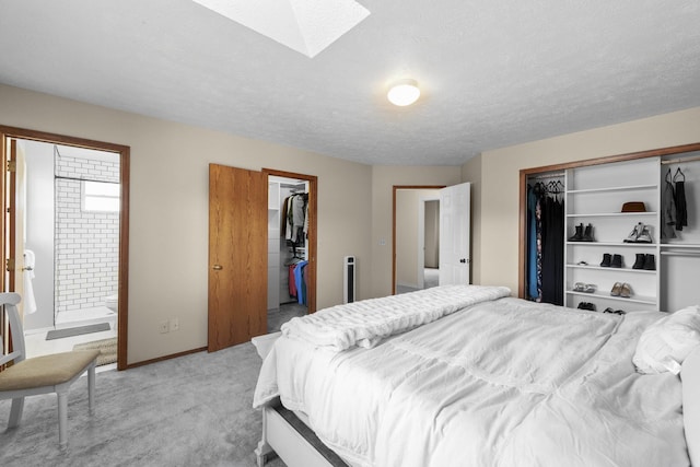 5706 W Excell Ave, Spokane, WA 99208 - bedroom with a skylight, light carpet, ensuite bath, and a textured ceiling