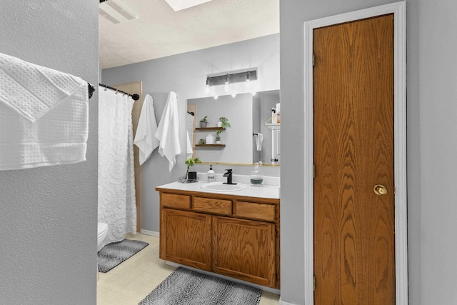 5706 W Excell Ave, Spokane, WA 99208 - full bath with vanity, a shower with shower curtain, a skylight, and tile patterned floors