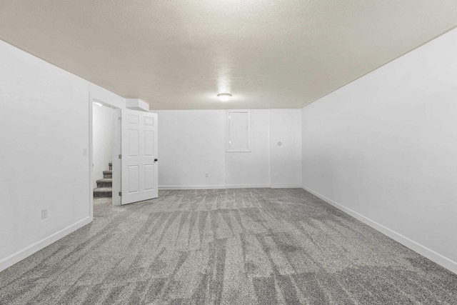 5706 W Excell Ave, Spokane, WA 99208 - additional living space with carpet, stairway, and a textured ceiling