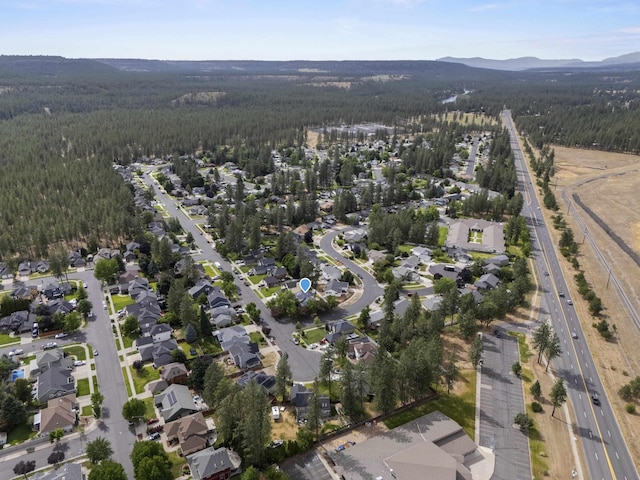 5706 W Excell Ave, Spokane, WA 99208 - aerial view of property's location featuring a heavily wooded area and a mountain backdrop