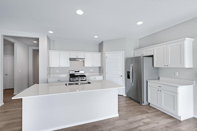 8410 W Sugar Ct, Cheney, WA 99004 - kitchen featuring appliances with stainless steel finishes, white cabinets, light wood finished floors, under cabinet range hood, and recessed lighting