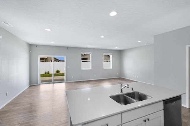 8410 W Sugar Ct, Cheney, WA 99004 - kitchen featuring dishwashing machine, light wood-type flooring, open floor plan, a center island with sink, and recessed lighting