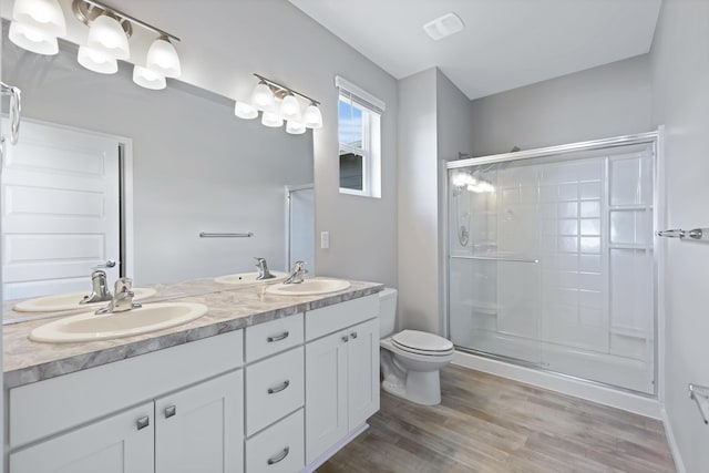 8410 W Sugar Ct, Cheney, WA 99004 - full bathroom featuring a stall shower, double vanity, and wood finished floors