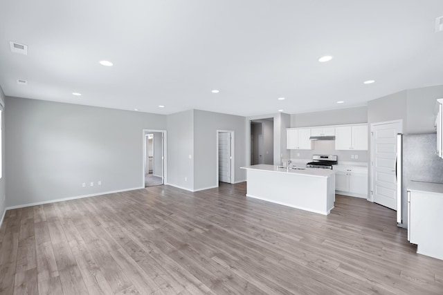 8410 W Sugar Ct, Cheney, WA 99004 - unfurnished living room featuring light wood finished floors and recessed lighting