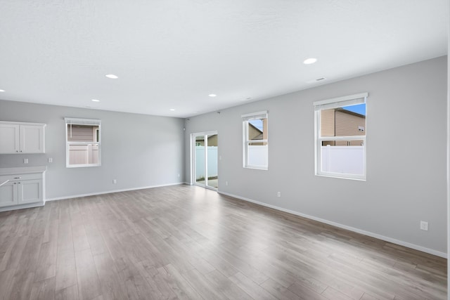 8410 W Sugar Ct, Cheney, WA 99004 - unfurnished living room with light wood-type flooring and recessed lighting