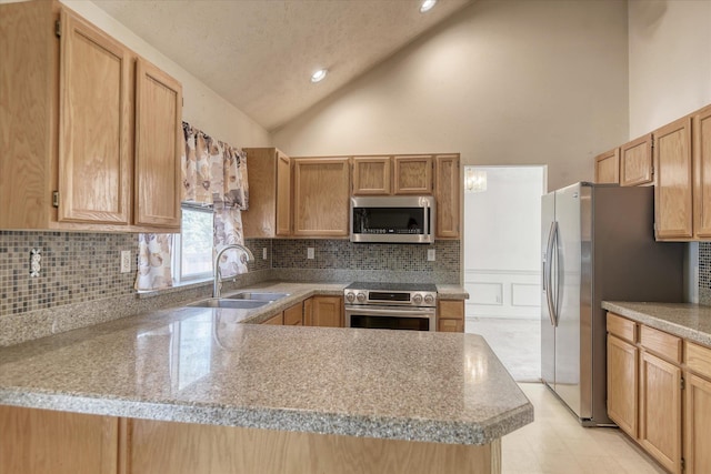 6919 N Pine Rock Pl, Spokane, WA 99208 - kitchen with stainless steel appliances, decorative backsplash, a peninsula, light countertops, and high vaulted ceiling