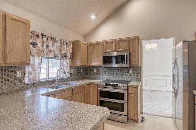 6919 N Pine Rock Pl, Spokane, WA 99208 - kitchen with stainless steel appliances, vaulted ceiling, tasteful backsplash, light countertops, and a chandelier