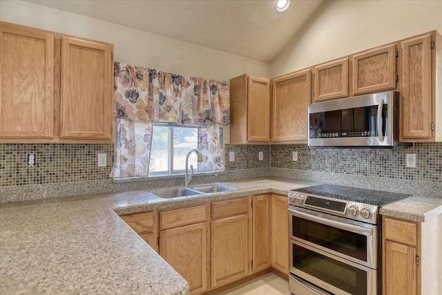 6919 N Pine Rock Pl, Spokane, WA 99208 - kitchen featuring appliances with stainless steel finishes, light countertops, lofted ceiling, and decorative backsplash