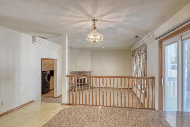 6919 N Pine Rock Pl, Spokane, WA 99208 - corridor with a chandelier and tile patterned floors