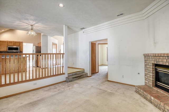 6919 N Pine Rock Pl, Spokane, WA 99208 - unfurnished living room featuring a fireplace and light colored carpet