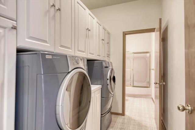 6919 N Pine Rock Pl, Spokane, WA 99208 - laundry room featuring washing machine and clothes dryer, light floors, and cabinet space
