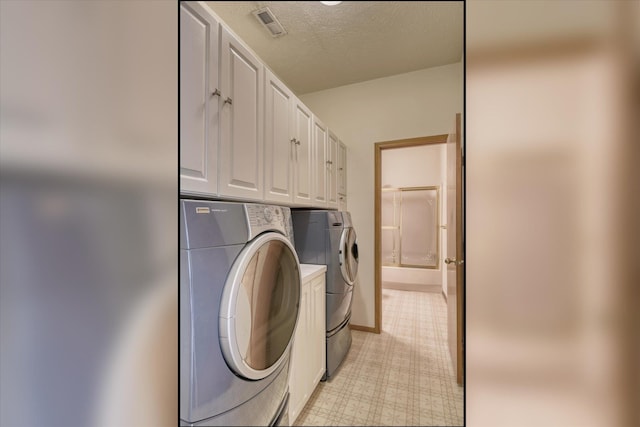 6919 N Pine Rock Pl, Spokane, WA 99208 - laundry area with independent washer and dryer, cabinet space, light flooring, and a textured ceiling