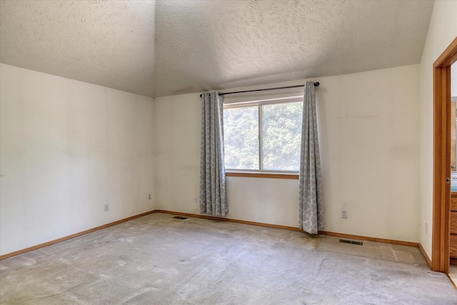 6919 N Pine Rock Pl, Spokane, WA 99208 - spare room with carpet floors, a textured ceiling, and lofted ceiling