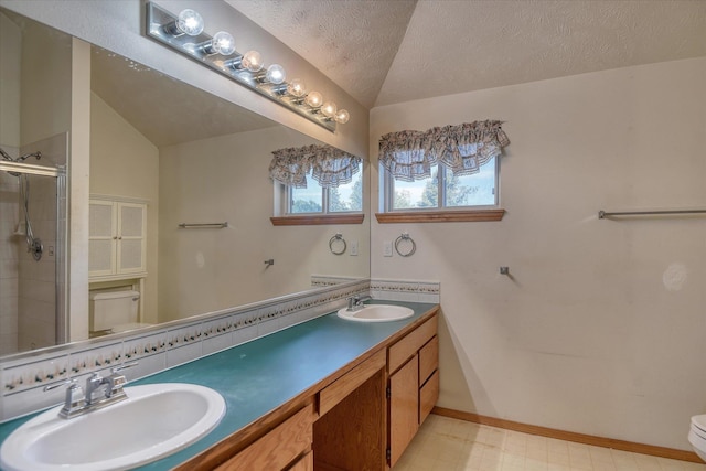6919 N Pine Rock Pl, Spokane, WA 99208 - full bathroom featuring a stall shower, double vanity, a textured ceiling, and tile patterned floors