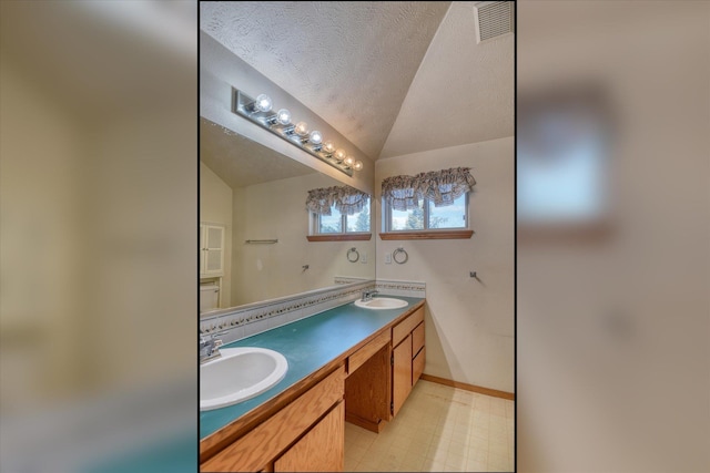 6919 N Pine Rock Pl, Spokane, WA 99208 - full bath with double vanity, tile patterned floors, and vaulted ceiling