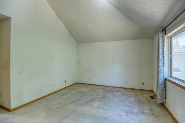 6919 N Pine Rock Pl, Spokane, WA 99208 - bonus room with vaulted ceiling, a textured ceiling, and light carpet