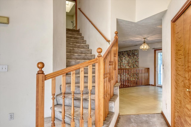 6919 N Pine Rock Pl, Spokane, WA 99208 - stairway featuring a chandelier