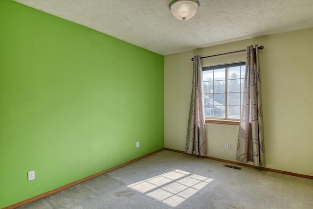6919 N Pine Rock Pl, Spokane, WA 99208 - empty room featuring a textured ceiling and carpet flooring