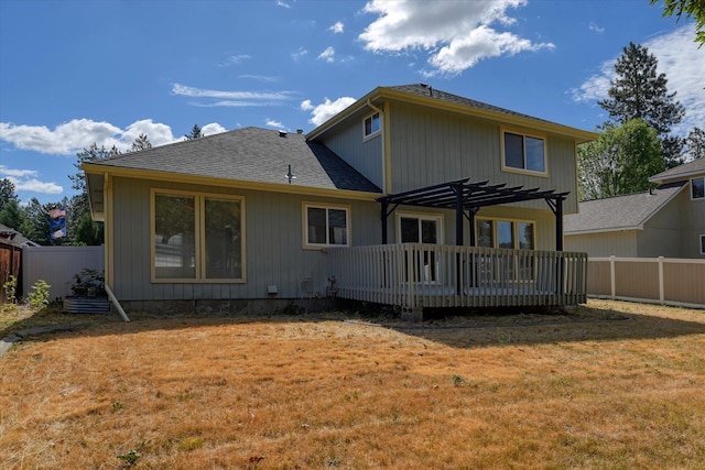 6919 N Pine Rock Pl, Spokane, WA 99208 - back of property featuring a deck, a pergola, a fenced backyard, and a shingled roof