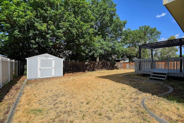 6919 N Pine Rock Pl, Spokane, WA 99208 - fenced backyard with a storage shed, a wooden deck, and a pergola