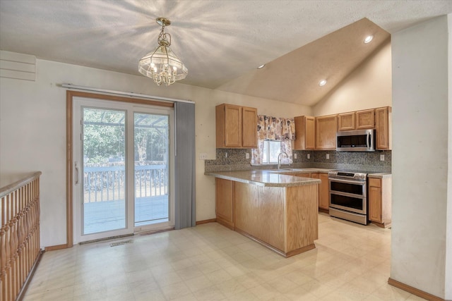 6919 N Pine Rock Pl, Spokane, WA 99208 - kitchen featuring appliances with stainless steel finishes, a peninsula, light floors, a chandelier, and tasteful backsplash