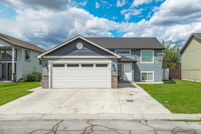17609 E 2nd Ln, Spokane Valley, WA 99016 - view of front of house with stone siding, a garage, a front lawn, and concrete driveway