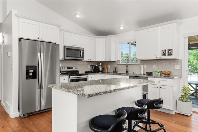 17609 E 2nd Ln, Spokane Valley, WA 99016 - kitchen featuring stainless steel appliances, wood finished floors, vaulted ceiling, decorative backsplash, and recessed lighting