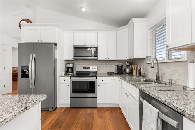 17609 E 2nd Ln, Spokane Valley, WA 99016 - kitchen with stainless steel appliances, lofted ceiling, white cabinetry, tasteful backsplash, and dark wood-type flooring