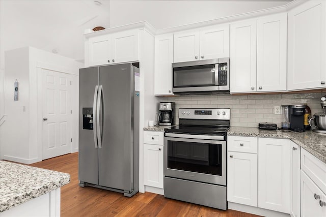 17609 E 2nd Ln, Spokane Valley, WA 99016 - kitchen with stainless steel appliances, wood finished floors, white cabinets, backsplash, and lofted ceiling