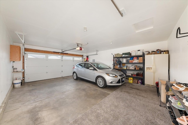 17609 E 2nd Ln, Spokane Valley, WA 99016 - garage with white fridge with ice dispenser and a garage door opener