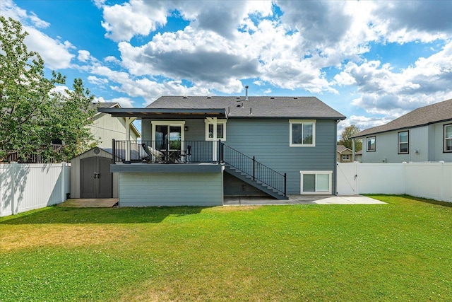 17609 E 2nd Ln, Spokane Valley, WA 99016 - rear view of property featuring a fenced backyard, stairway, a storage unit, and a deck