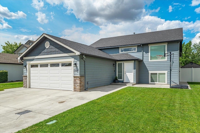 17609 E 2nd Ln, Spokane Valley, WA 99016 - view of front of house featuring a garage, concrete driveway, stone siding, and a shingled roof
