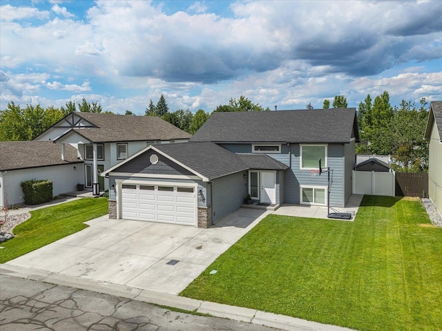 17609 E 2nd Ln, Spokane Valley, WA 99016 - view of front of house featuring an attached garage, concrete driveway, roof with shingles, and stone siding