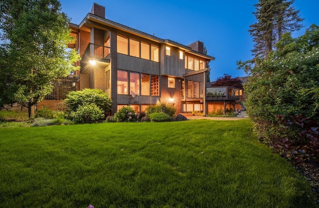 6624 S Ben Burr Rd, Spokane, WA 99223 - rear view of property featuring a chimney, a lawn, and a balcony