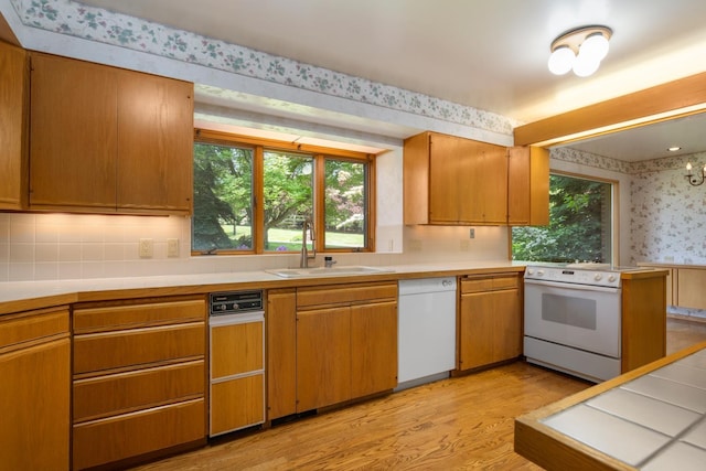 6624 S Ben Burr Rd, Spokane, WA 99223 - kitchen with white appliances, wallpapered walls, light wood-type flooring, light countertops, and plenty of natural light